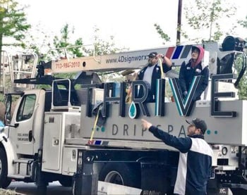 4D Signworx crew installing Houston outdoor signage for Thrive Drip Spa