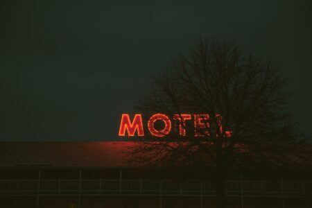 Tree blocking motel Houston outdoor signs